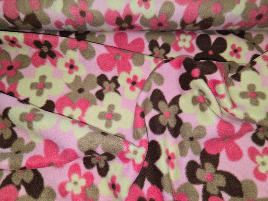 Floral fabric with pink, green, and brown flowers on a pink background